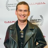 Robert Burns smiling headshot on the red carpet at the Culver City Film Festival
